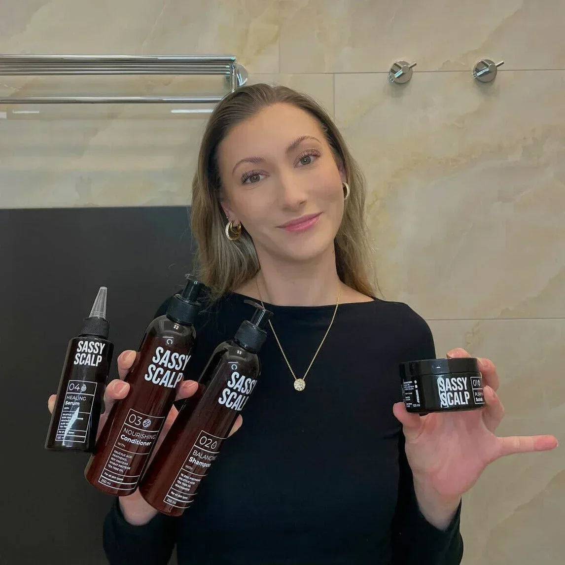 scalp kit person holding the products