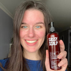 nourishing conditioner person holding the product