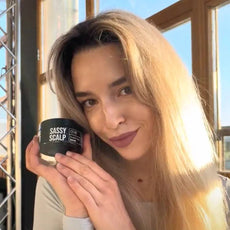 purifying scrub person holding the product