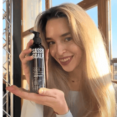 balancing shampoo person holding the product